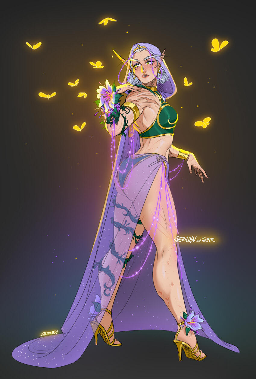 Erilihn in green and gold formal attire with a hooded cape and skirt made of sparkly sheer lavender fabric. She has flowering green vines looping up one leg and around one arm. Golden butterflies float around her.